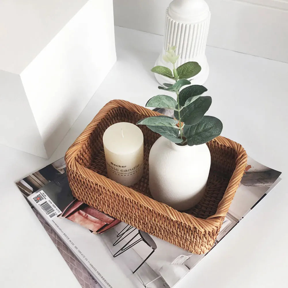 Wicker basket with a candle and plant on a magazine boho home decor, rattan basket, handwoven wicker basket, fruit storage box, bread basket, picnic basket, natural storage bin, tea storage box, rustic home organization, farmhouse decor, housewarming gift, boho storage basket
