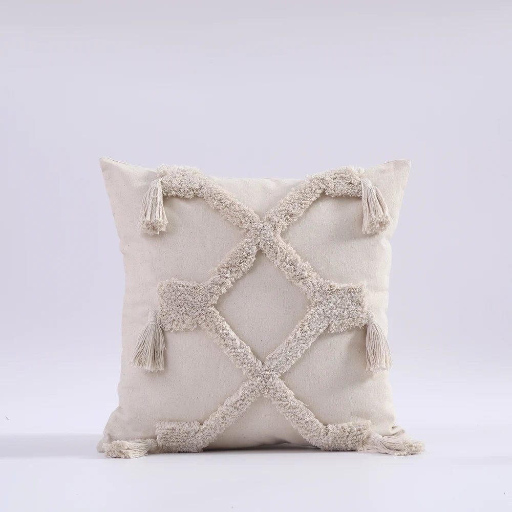 Decorative pillow with tassels on a light gray background
