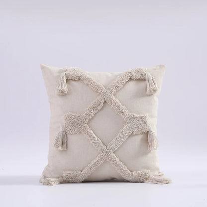 Decorative pillow with tassels on a light gray background