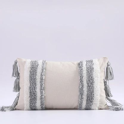 Decorative pillow with tassels on a light gray background