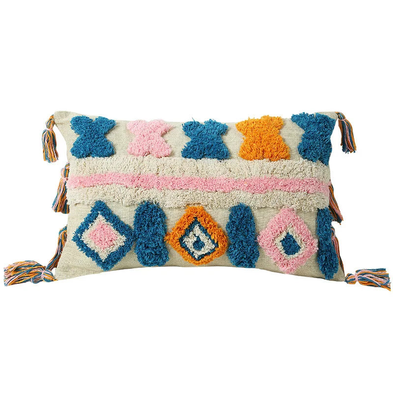 Decorative pillow with colorful geometric patterns and tassels on a white background
