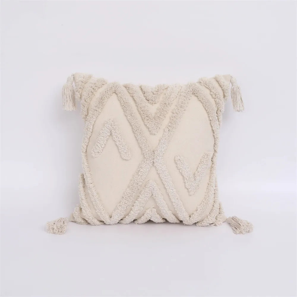 Textured cream pillow with braided design on a light gray background