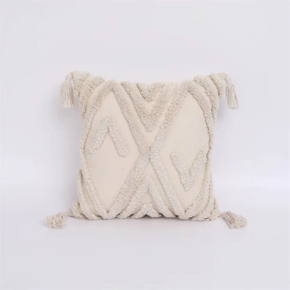 Textured cream pillow with braided design on a light gray background