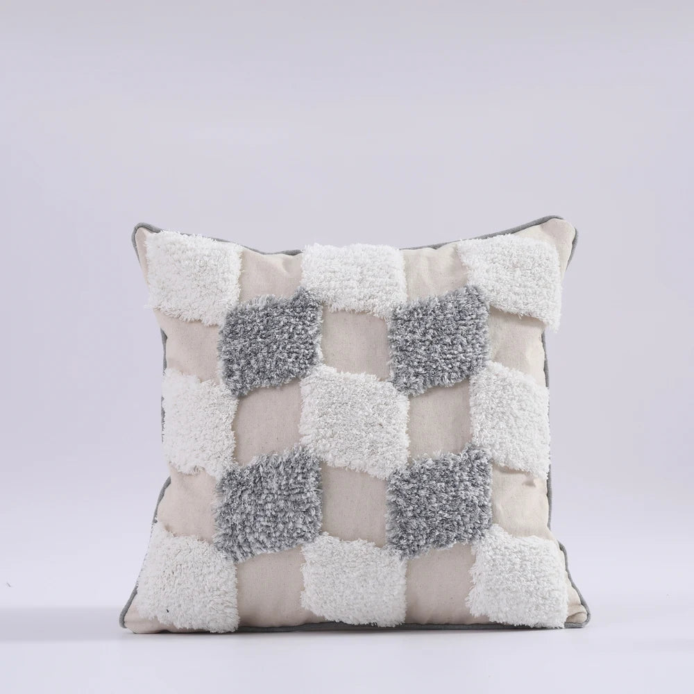 Decorative pillow with a checkered pattern on a light gray background