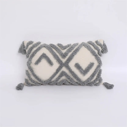 Decorative pillow with geometric pattern and tassels on a white background
