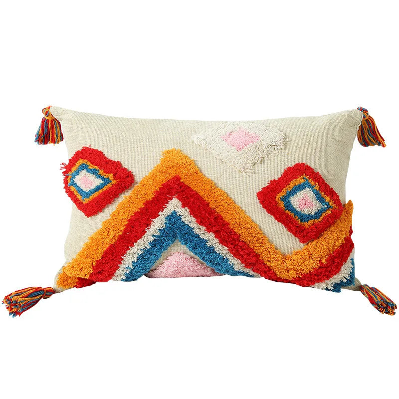 Colorful pillow with geometric pattern and tassels on a white background