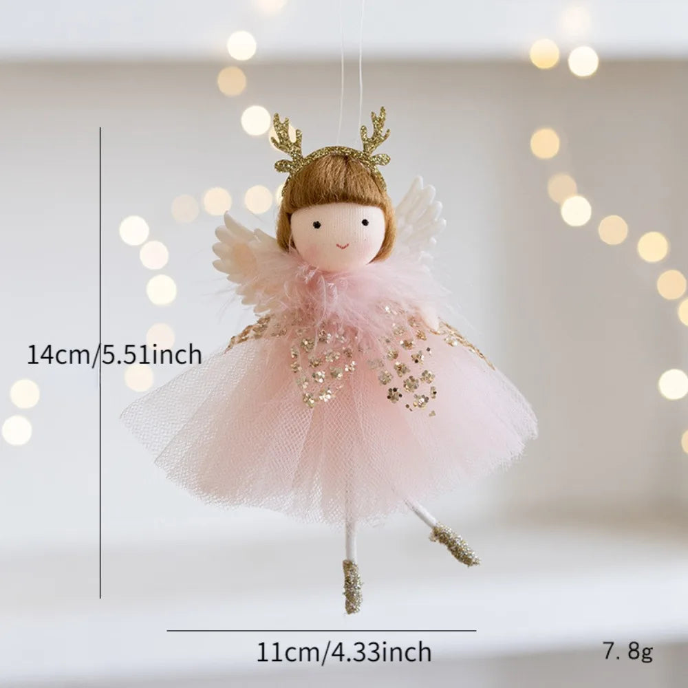 Small fairy doll Christmas Ornament with a pink dress and gold accents, hanging against a soft bokeh background.