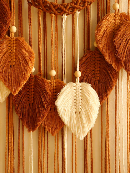 Macrame wall hanging with brown and beige leaves on a striped background