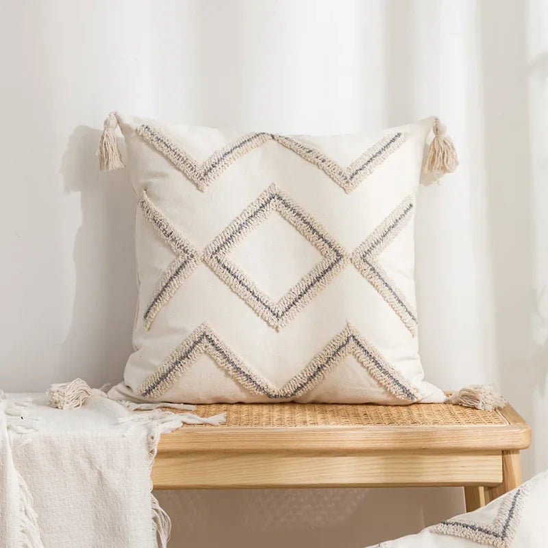 Decorative pillow with zigzag pattern on a wooden bench against a white wall Nordic blue tufted cushion cover with geometric stripe and grid crochet pattern, tassel pillow cover for sofa, bed, and boho home decor