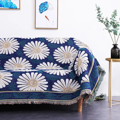 Blue floral patterned throw blanket on a sofa in a living room setting. Mediterranean style woven cotton throw blanket boho home decor