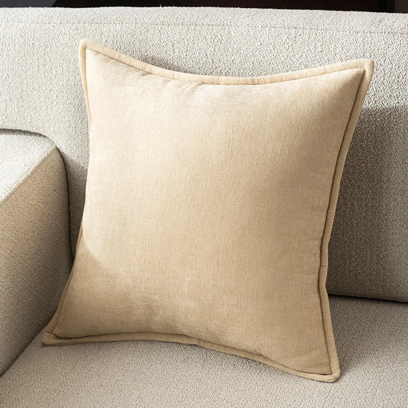 Beige pillow on a textured beige sofa