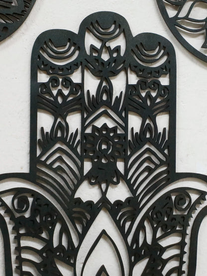 Close-up of evil eye ornament in black hand-shaped wooden wall hanging, ideal for witchy boho home decor or spiritual protection.