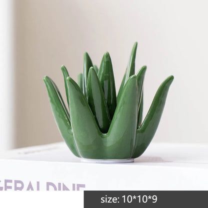 Green ceramic vase with unique design on a white surface. Green ceramic cactus jewelry storage dish for home decor