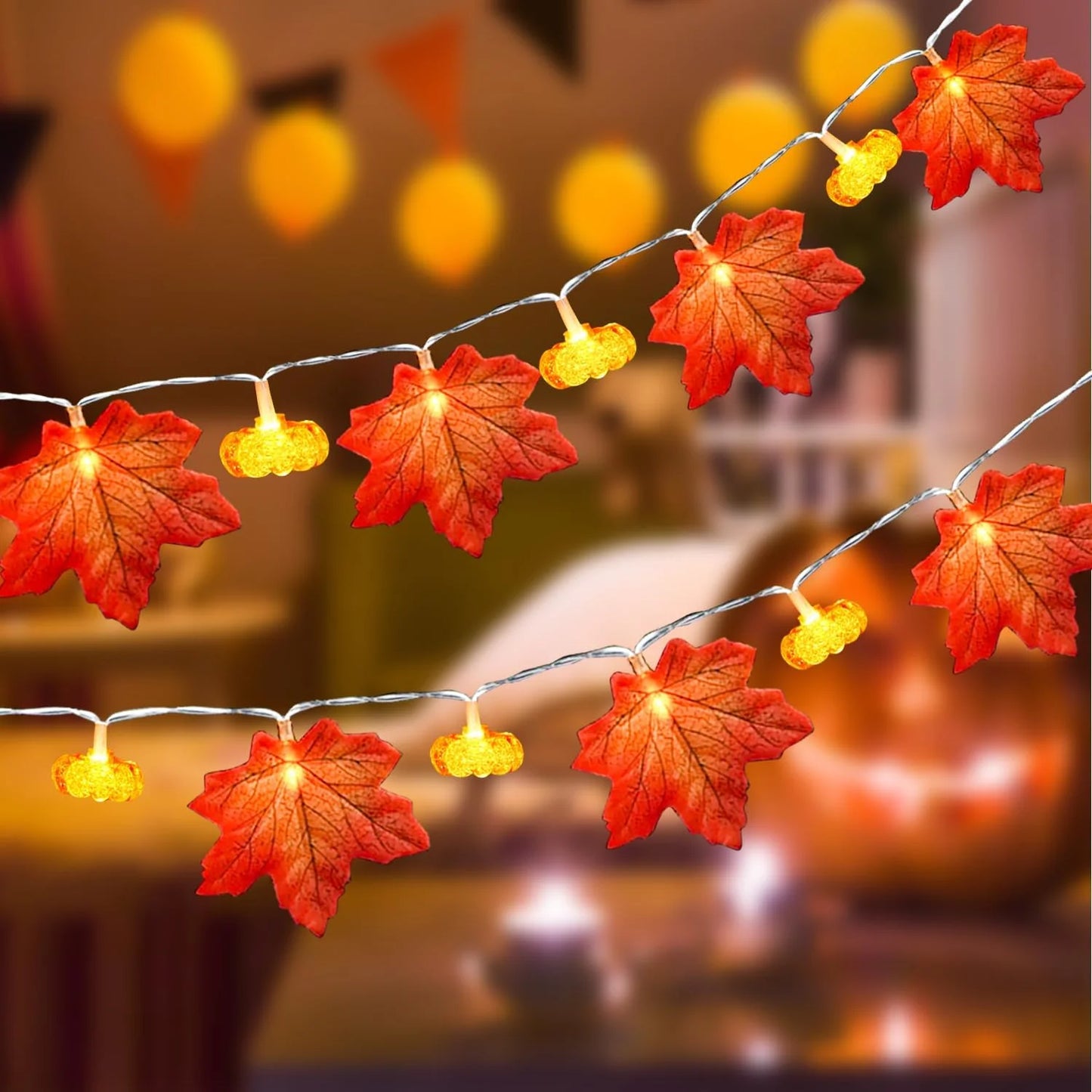 String lights with red and yellow leaf decorations on a blurred background. fall leaf lights 