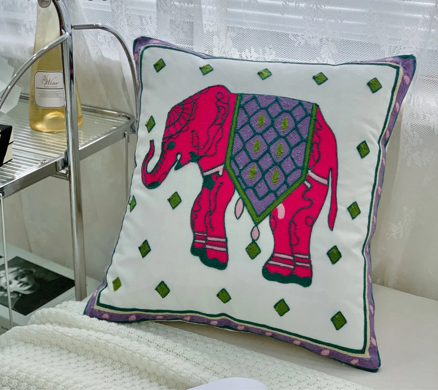 Decorative pillow with a pink elephant design on a white surface, floral embroidery on linen cotton cushion cover – boho home decor accent