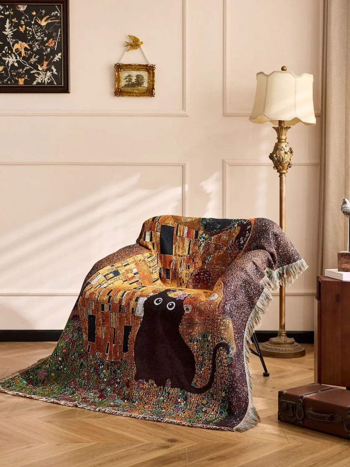 Decorative blanket with a cat design draped over a chair in a room with a lamp and wall art.Cat woven throw blanket for boho sofa and home decor