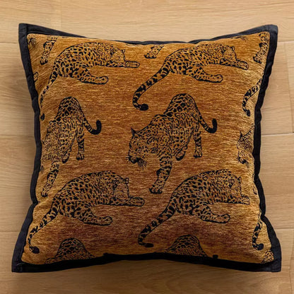 Decorative pillow with leopard patterns on a wooden surface. embroidery throw pillow cover in boho modern style.