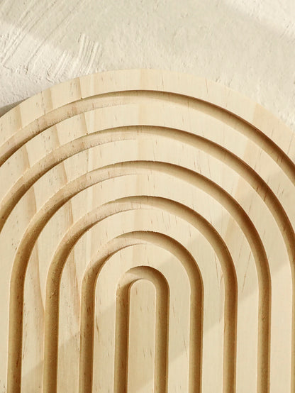 Wooden arches arranged in a circular pattern on a light background