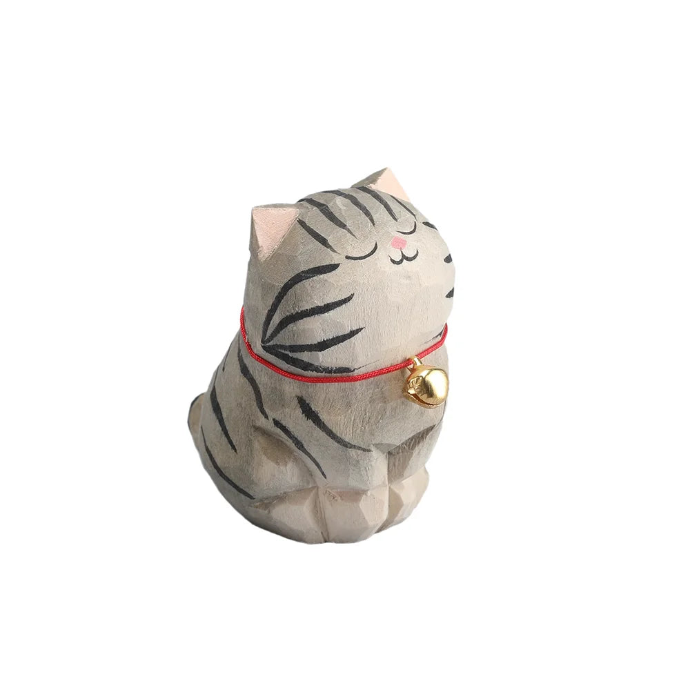 Cat-shaped plush toy with a red collar and gold bell on a white background