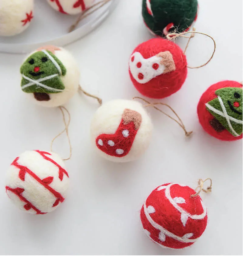 Felt wool Christmas ornaments shaped like gingerbread men, snowmen, and stockings on a white background.