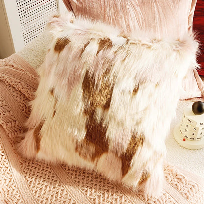 Furry pillow on a textured surface with a blurred background. Boho Home Decor. 