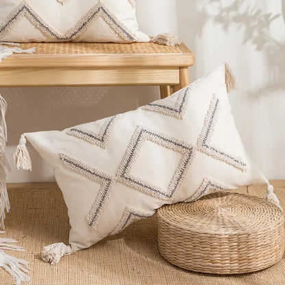 Decorative pillow with geometric pattern on a woven stool in a home setting Nordic blue tufted cushion cover with geometric stripe and grid crochet pattern, tassel pillow cover for sofa, bed, and boho home decor