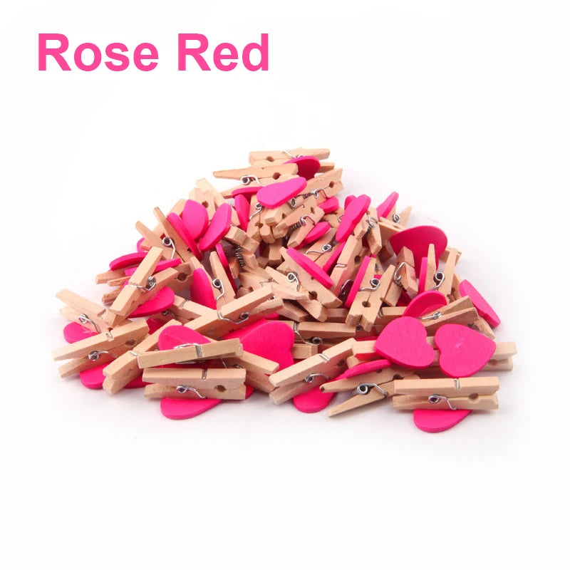 Pile of wooden clothespins with pink heart-shaped ends on a white background, labeled 'Rose Red'.