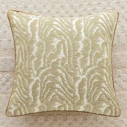 Decorative pillow with a leaf pattern on a textured surface.embroidery throw pillow cover in boho modern style