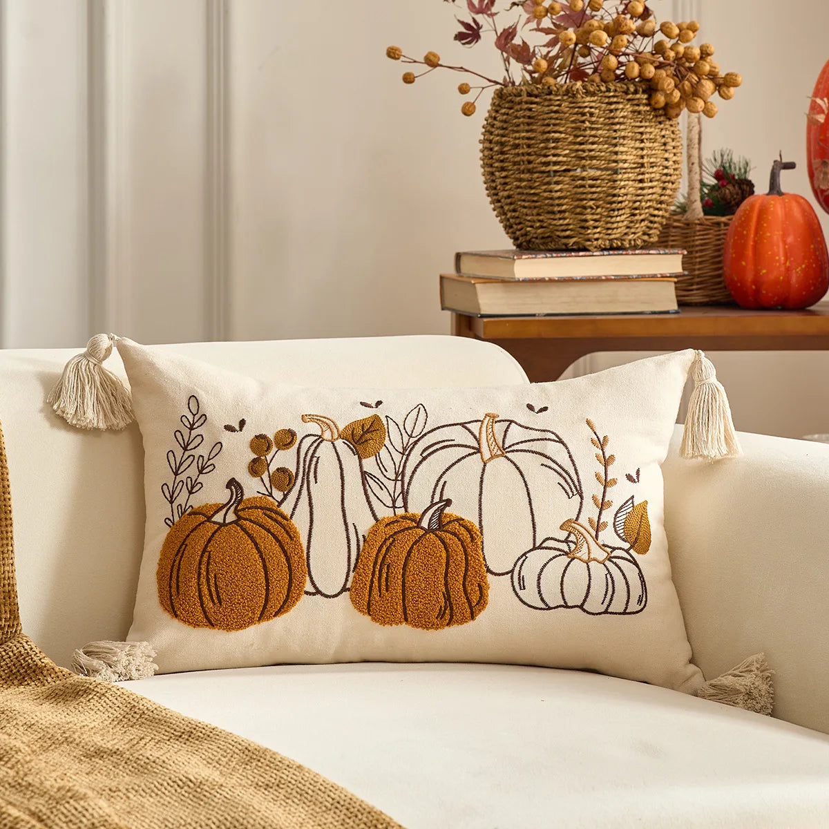 Decorative pillow with pumpkin design on a couch, with a cozy autumn setting in the background. Halloween and Thanksgiving decorative pillow cover For Fall