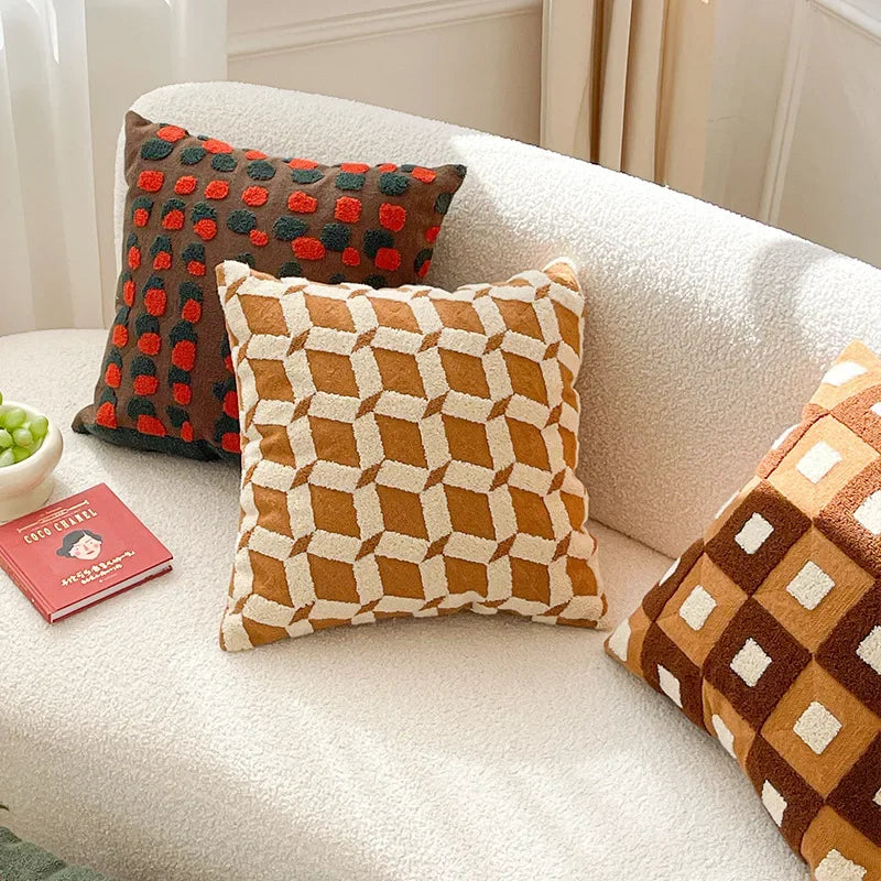 Decorative pillows on a white sofa with a book and bowl of grapes. Bohemian embroidered throw pillow cover 18x18 inch with geometric towel embroidery, decorative cushion for sofa, bed, or living room boho home decor