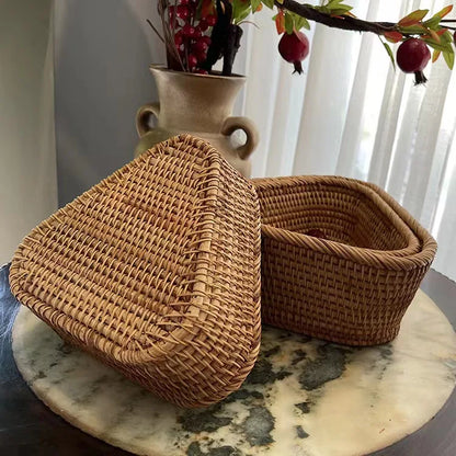 Woven baskets on a marble surface with a vase and pomegranate branch in the background. boho home decor, rattan basket, handwoven wicker basket, fruit storage box, bread basket, picnic basket, natural storage bin, tea storage box, rustic home organization, farmhouse decor, housewarming gift, boho storage basket