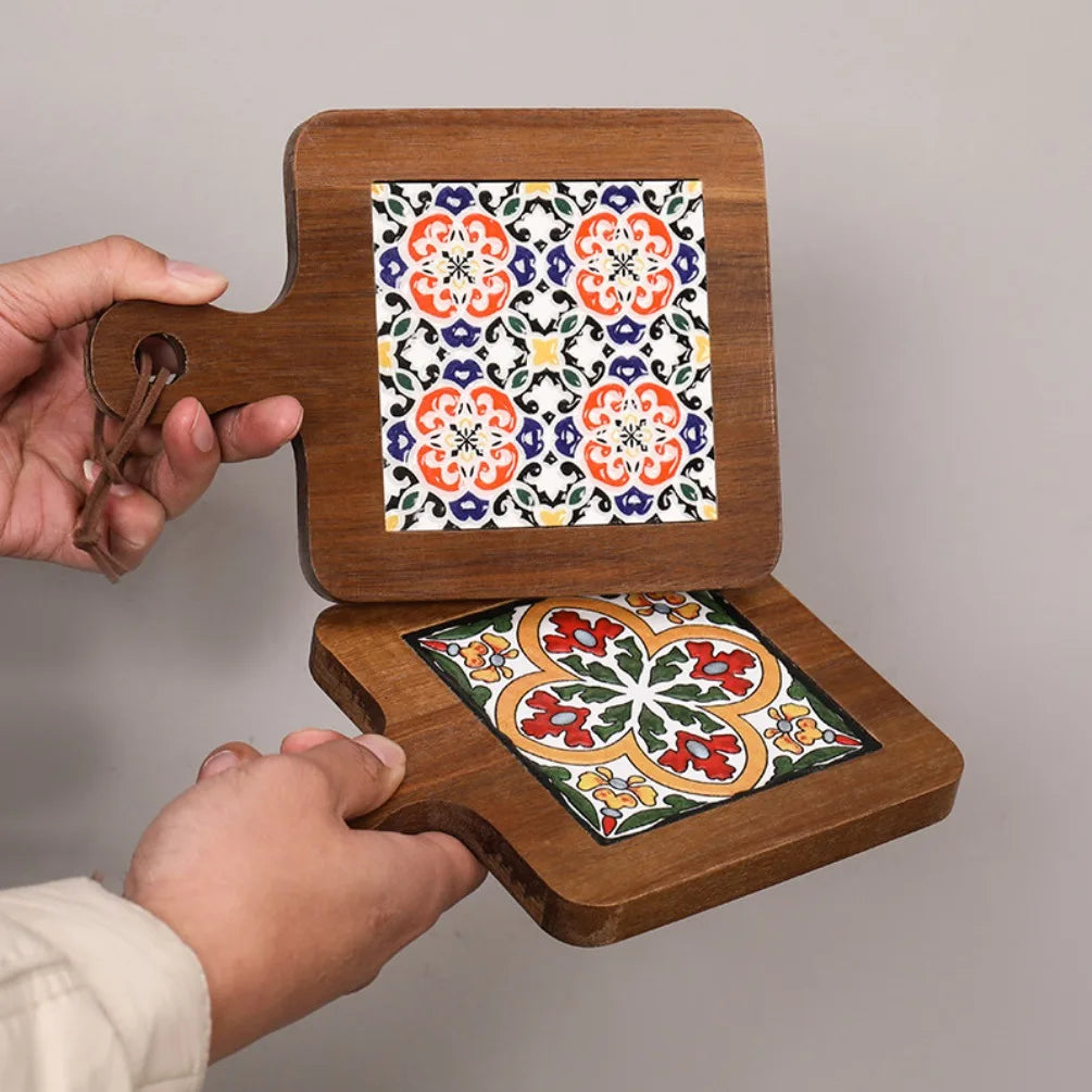 Wooden holder with two decorative tiles featuring floral patterns on a plain background