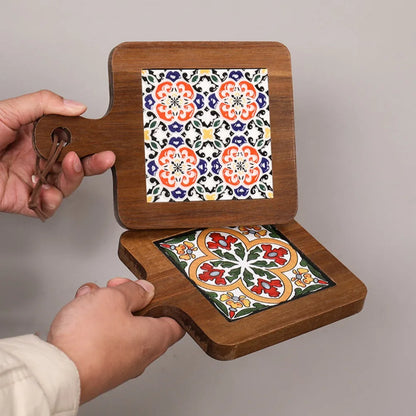 Wooden holder with two decorative tiles featuring floral patterns on a plain background