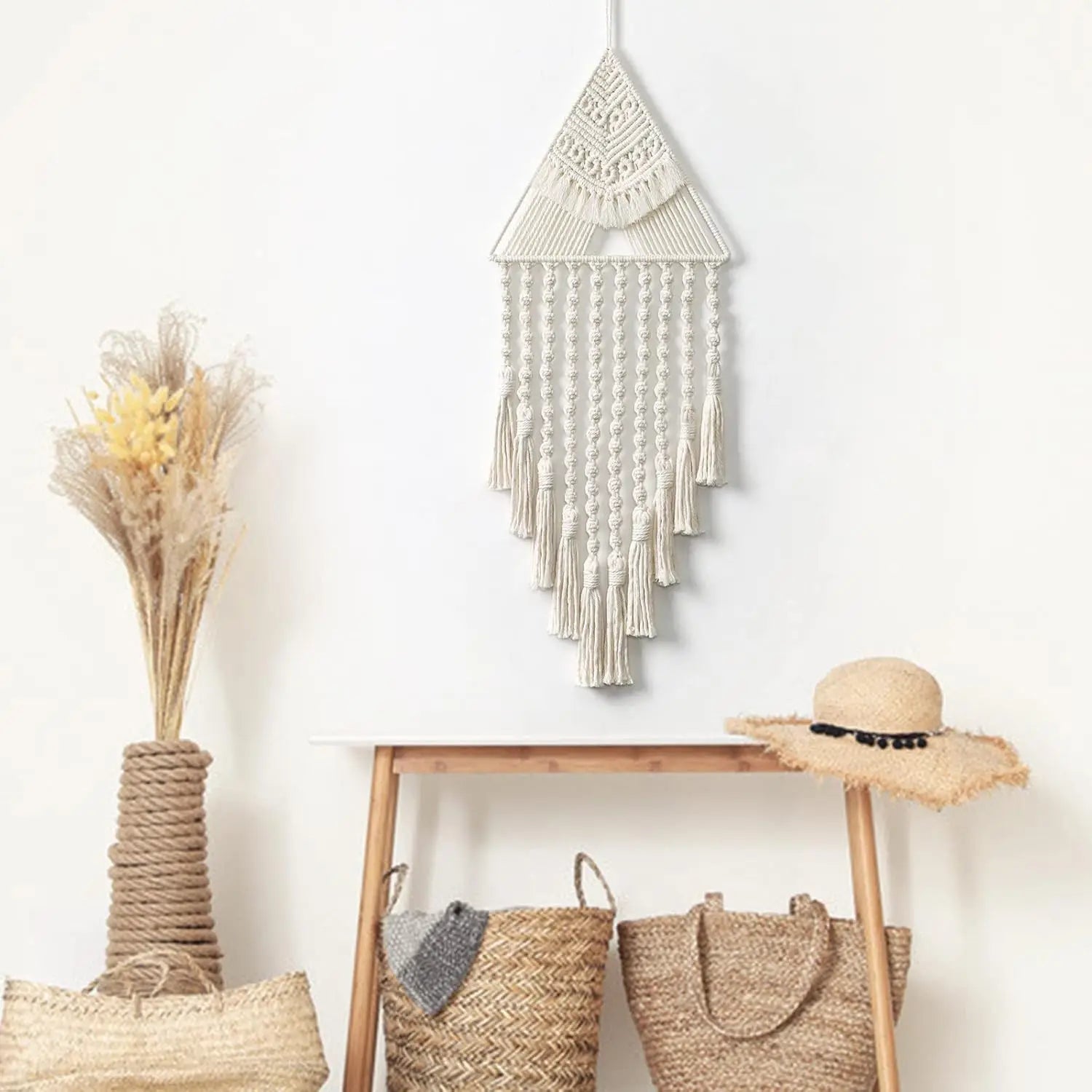 Decorative wall hanging with baskets and a hat on a wooden shelf against a white wall. boho home decor, macrame wall hanging, triangle dream catcher, woven tapestry, handmade cotton wall decor, tassel wall hanging, bedroom door decor, housewarming gift, rustic bohemian art, boho apartment wall decor, neutral textile art