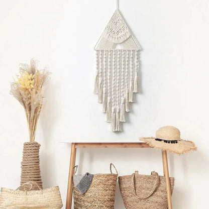 Decorative wall hanging with baskets and a hat on a wooden shelf against a white wall. boho home decor, macrame wall hanging, triangle dream catcher, woven tapestry, handmade cotton wall decor, tassel wall hanging, bedroom door decor, housewarming gift, rustic bohemian art, boho apartment wall decor, neutral textile art