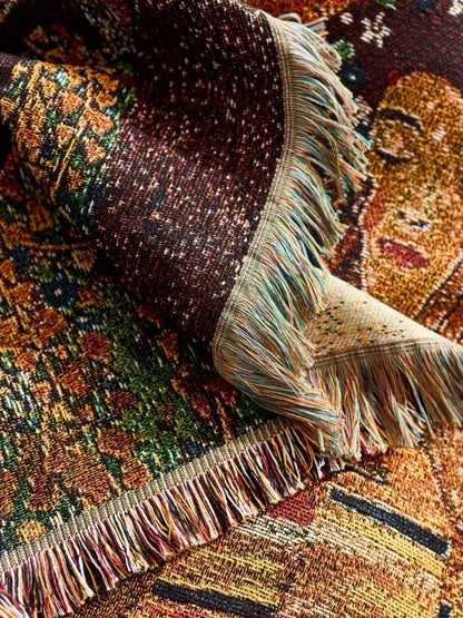 Close-up of a textured fabric with fringes on a patterned background. Cat woven throw blanket for boho sofa and home decor