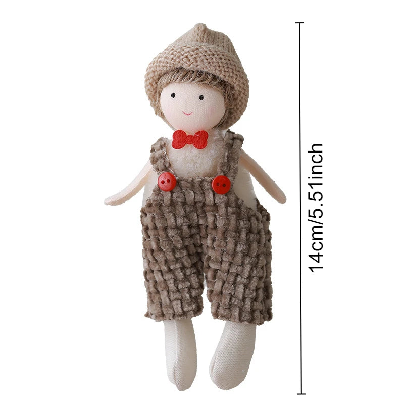 Toy figure with knitted hat and overalls, standing next to a measurement label indicating height.