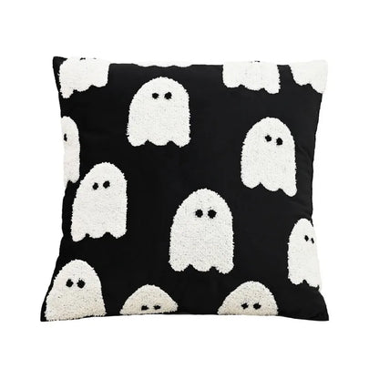 Black pillow with white ghost patterns on a white background