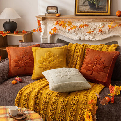 Cozy living room with a fireplace, decorated with autumn-themed pillows and decor. Halloween pumpkin plush pillow cover for sofa and bed decor.