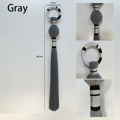 Gray decorative ring with tassel on a white background. boho macrame wall art