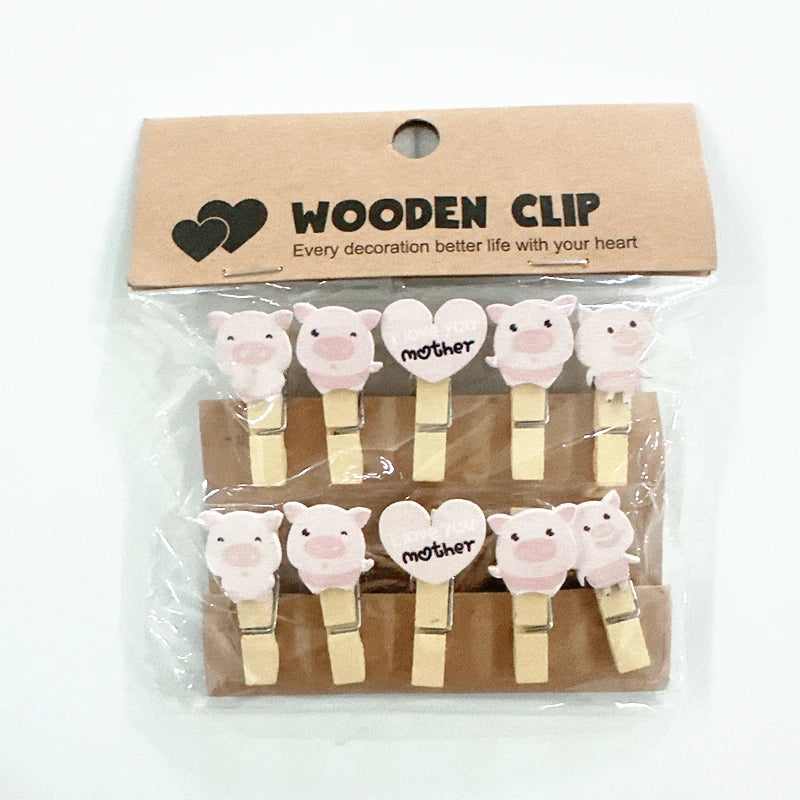 Packaged wooden clips with pig and heart designs on a white background