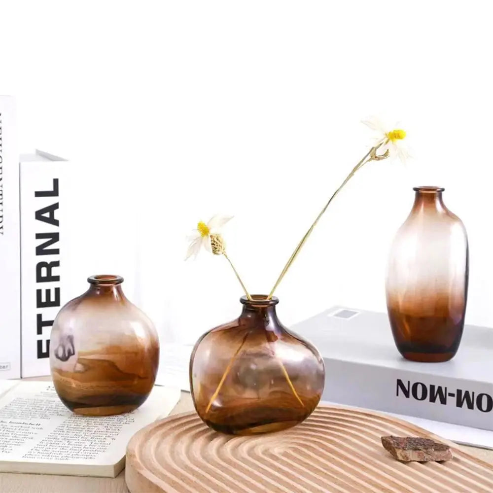 Three gradient brown vases on a wooden surface with books in the background. Boho Home Decor