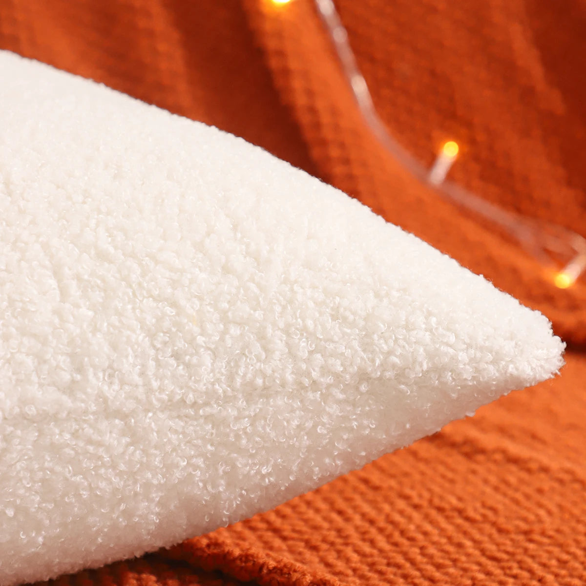 Close-up of white textured fabric on an orange background. fall boho pillow throw gift ideas