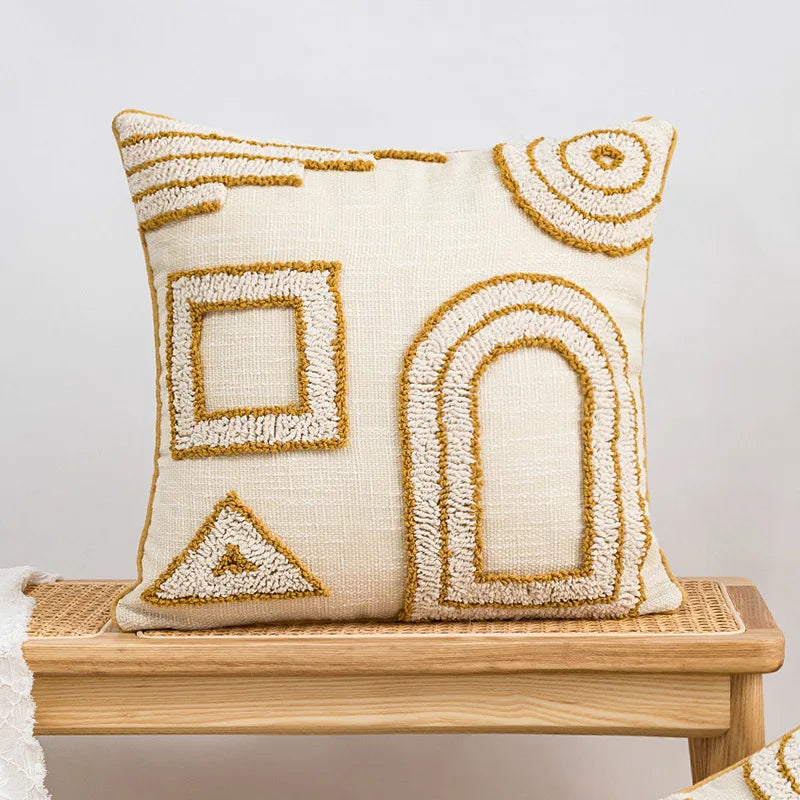 Decorative pillow with geometric patterns on a wooden bench against a white background Nordic blue tufted cushion cover with geometric stripe and grid crochet pattern, tassel pillow cover for sofa, bed, and boho home decor