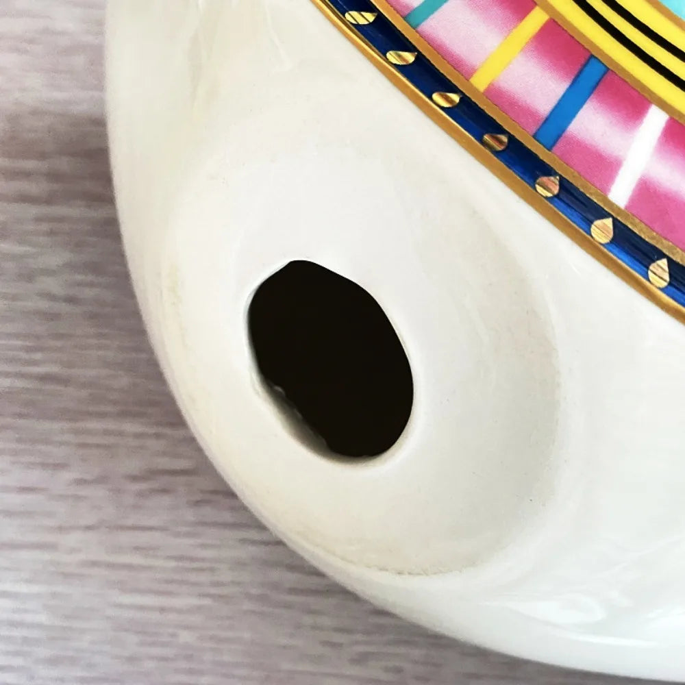 Close-up of the hollow base with hole of Moroccan Turkish blue evil eye ceramic figurine, showcasing handcrafted bohemian home decor details, perfect for unique and modern boho home accents and thoughtful boho gifts.