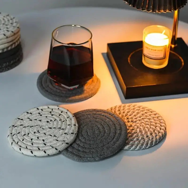 Set of round coasters on a table with a glass of red wine and a candle. Set of cotton drink coasters – eco-friendly housewarming gift idea