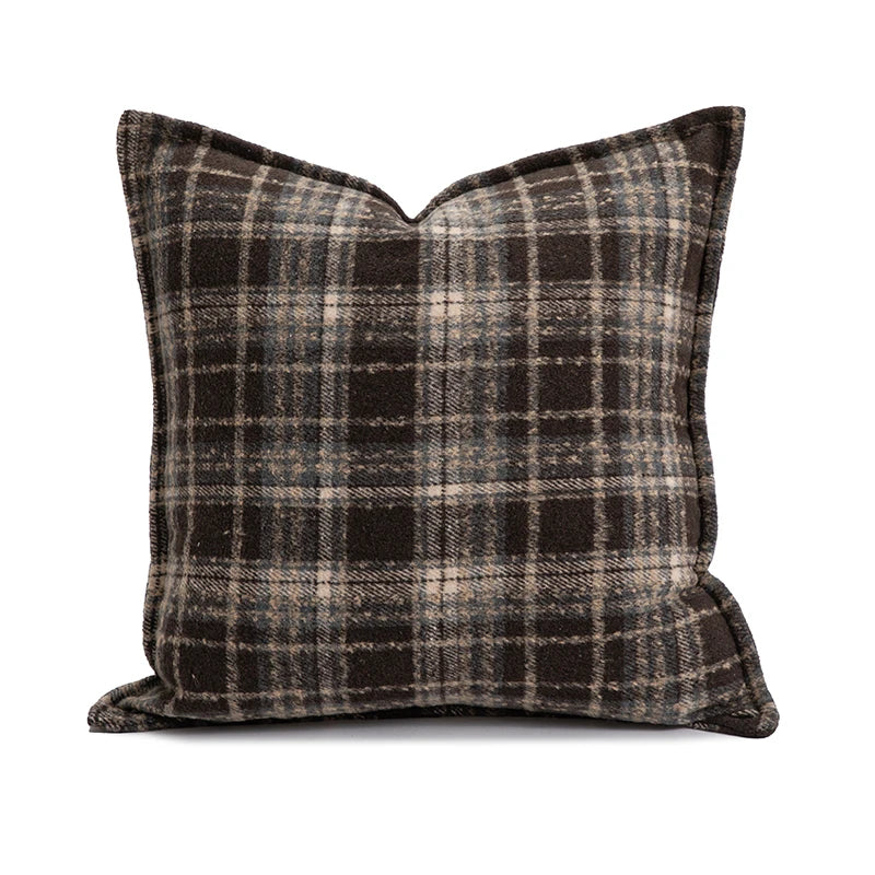 Plaid pillow with black and beige pattern on a white background