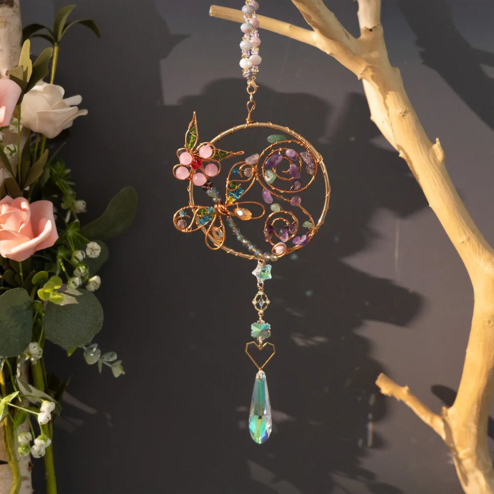 Decorative hanging ornament with floral elements and a teardrop pendant on a dark background. butterfly flower boho home decor, crystal wind chime, sun catcher for windows, moon prism chime, agate stone hanging, garden art decor, patio hanging decoration, boho housewarming gift, spiritual gift, crystal suncatcher, balcony decor, meditation decor, handmade crystal chime