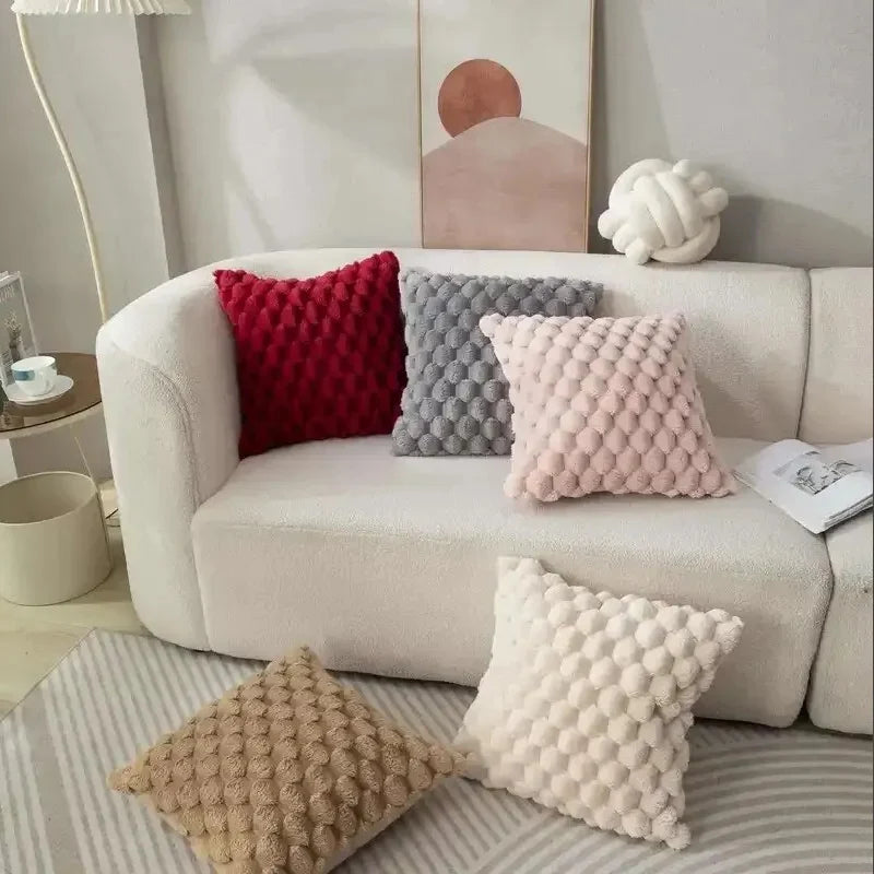 Decorative pillows on a sofa in a living room setting