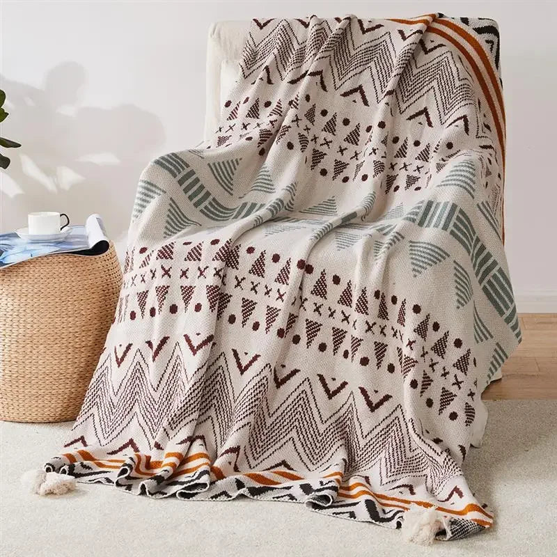 Bohemian Patterned blanket draped over a chair with a neutral background